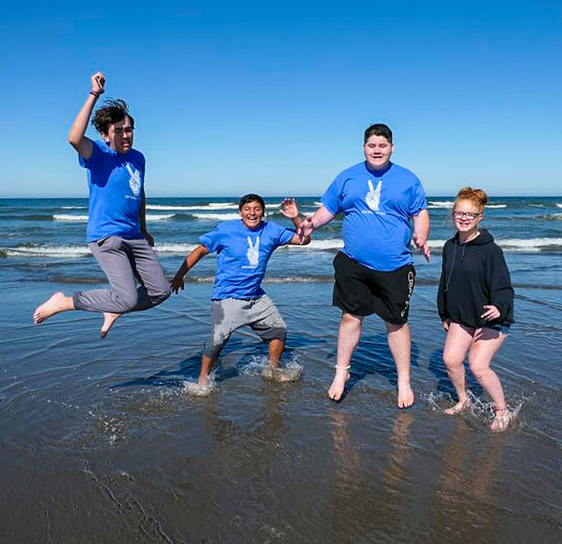 Ocean Park people jumping into ocean in celebration